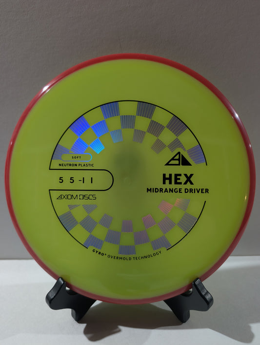 Disc golf disc with 'Hex' and 'Axiom Discs' branding on a stand.