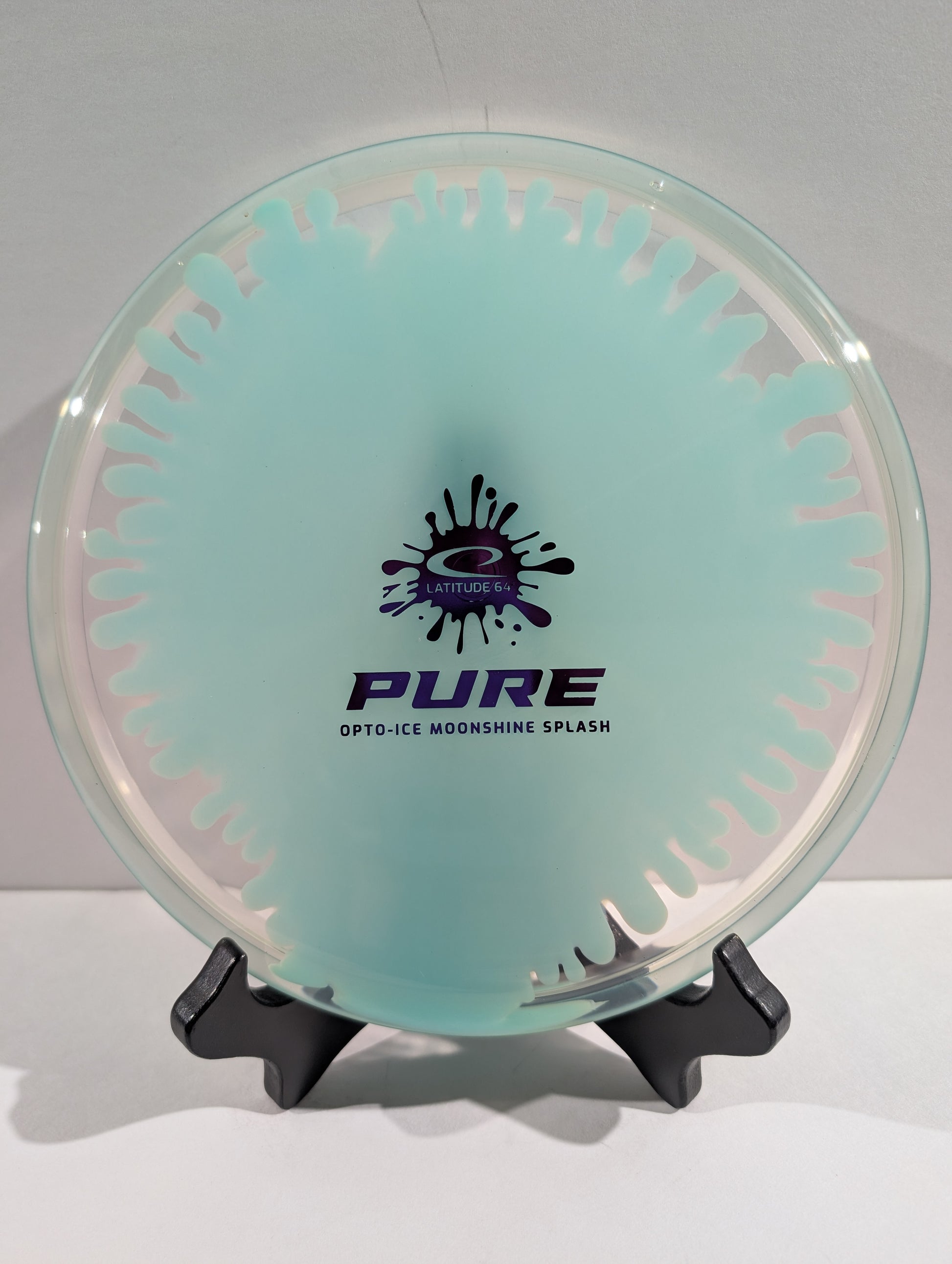 Clear and blue disc with 'PURE' branding on a stand against a white background