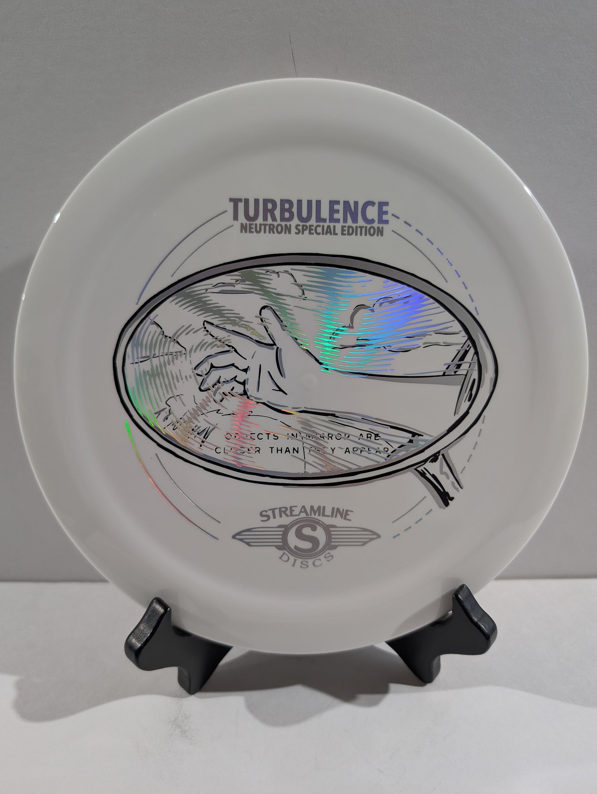 White disc with 'Turbulence' and 'Neutron Special Edition' text on a stand against a gray background