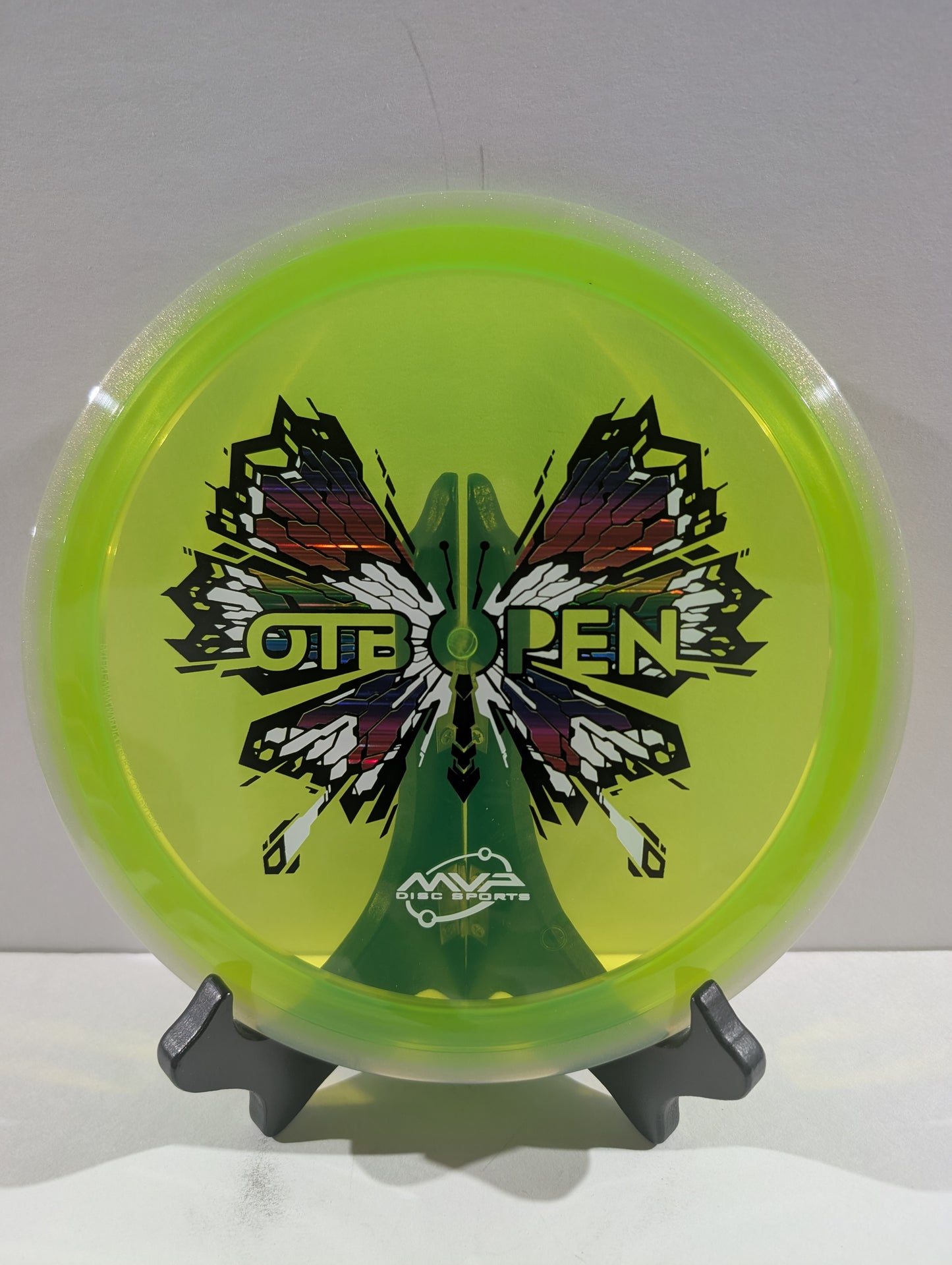 Disc with butterfly design and 'OTB Open' branding on a white background
