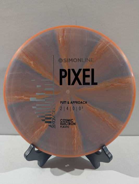 A disc golf disc on a small display stand, featuring an orange rim and a marbled pink and orange flight plate with black printed text.