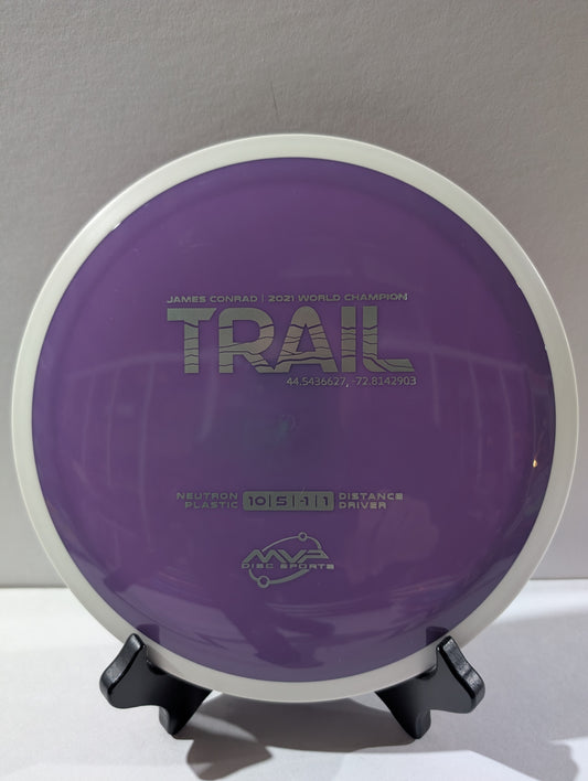 Purple disc golf disc with branding on a stand against a neutral background