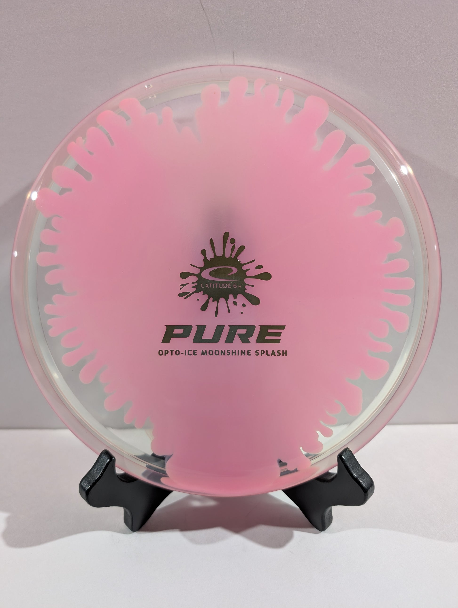 Pink and clear disc with 'PURE' branding on a stand against a white background