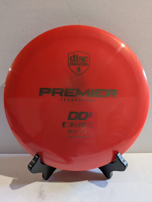 Red disc with Discmania branding on a stand against a neutral background