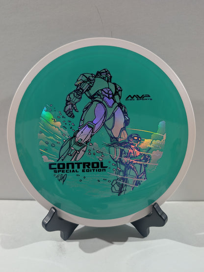 A disc golf disc on a small display stand, featuring a teal green background with a purple and black robot graphic, the text 'CONTROL SPECIAL EDITION', and an 'AWA' logo.