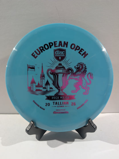 A light blue Discmania European Open disc golf disc displayed on a small black stand against a neutral light gray background.