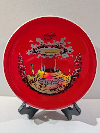 Red disc with 'Stasis' design on a stand against a white background
