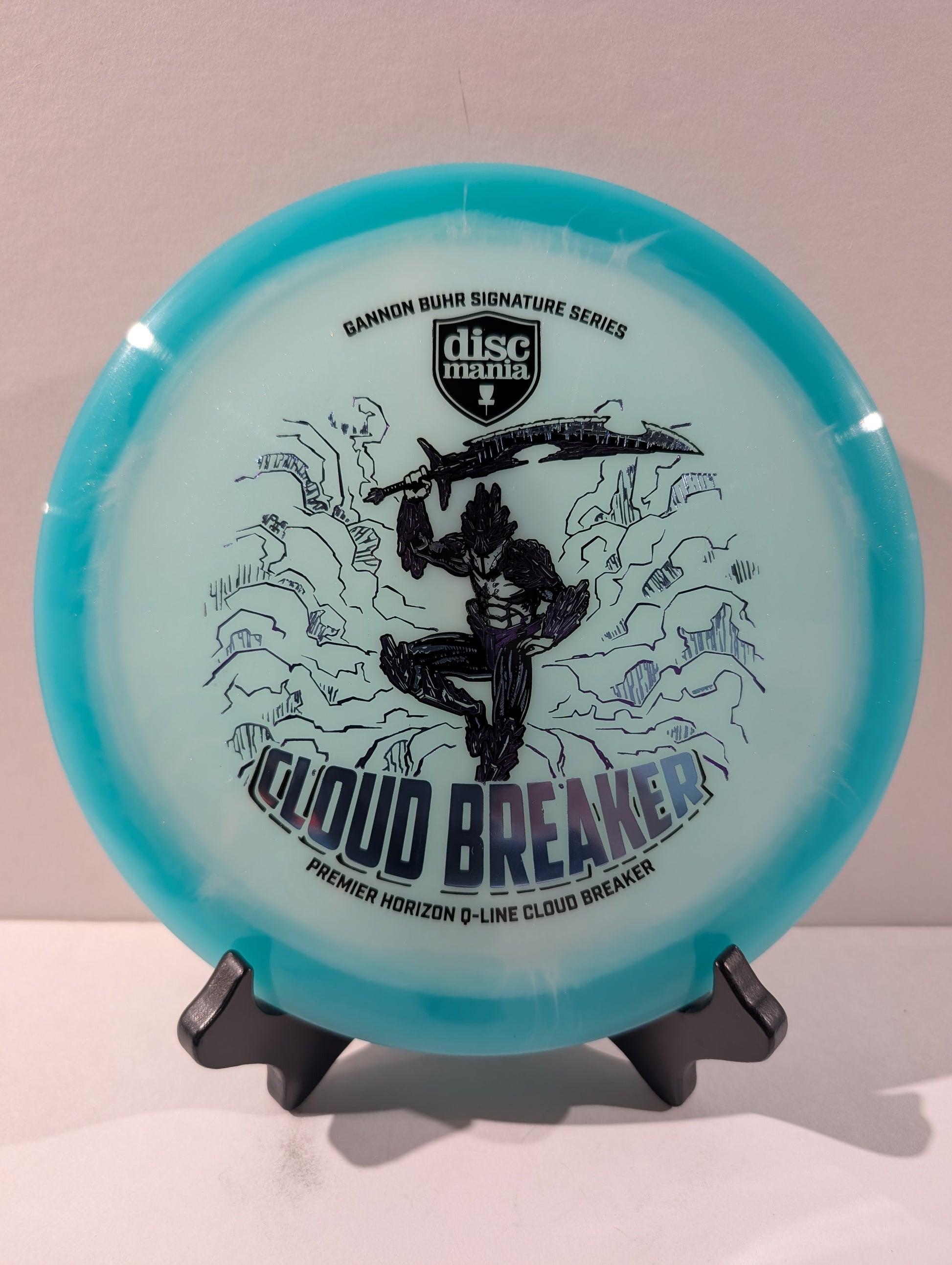 Disc golf disc with 'Cloud Breaker' and 'Discmania' branding on a stand.