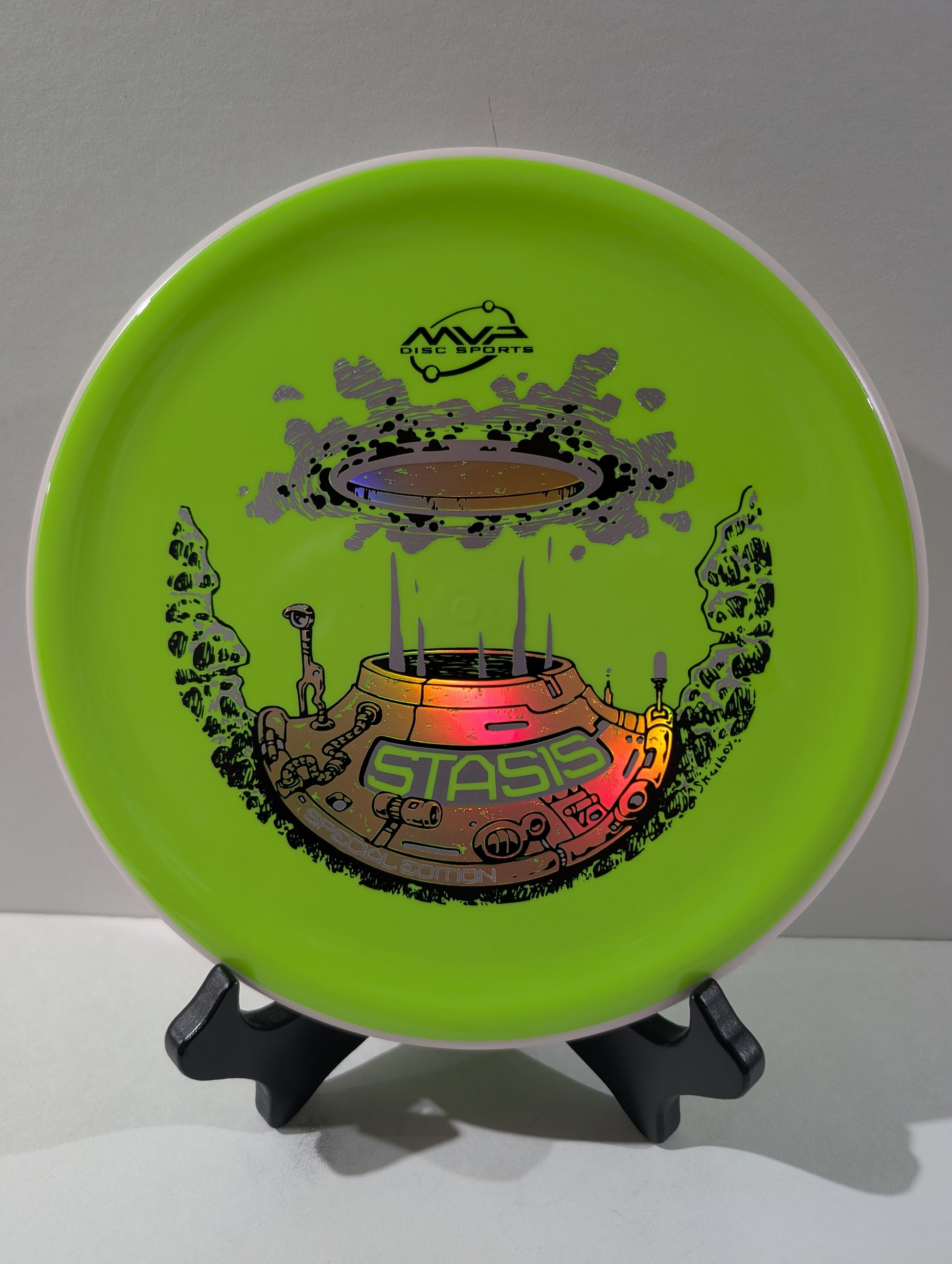 Dayglow disc with a colorful design on a stand against a white background