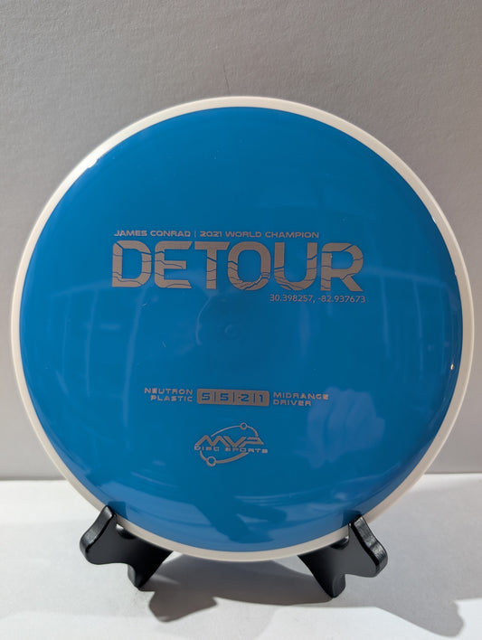 Blue disc golf disc on a stand with branding and text