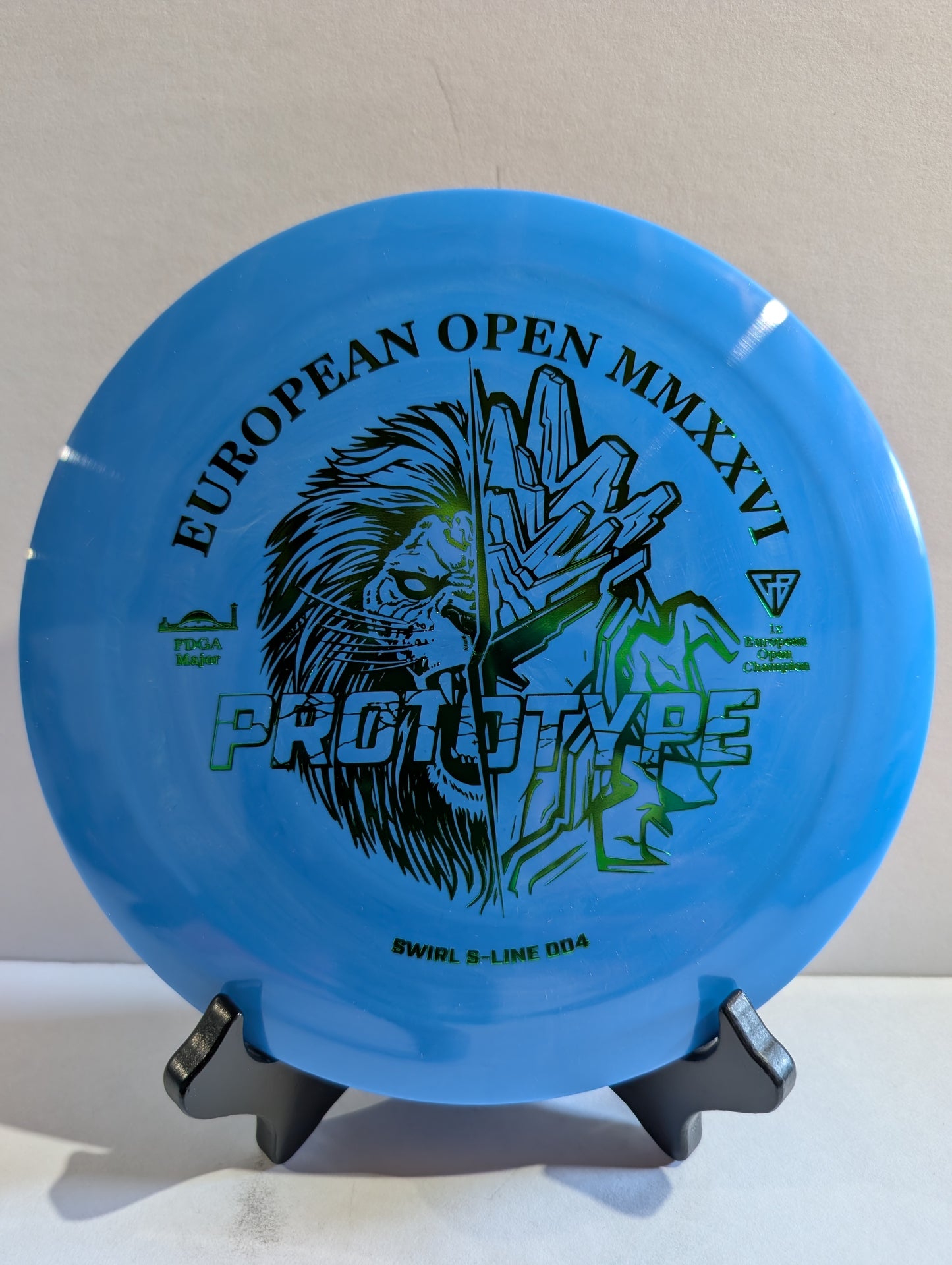 Blue disc with branding and text on a stand against a neutral background