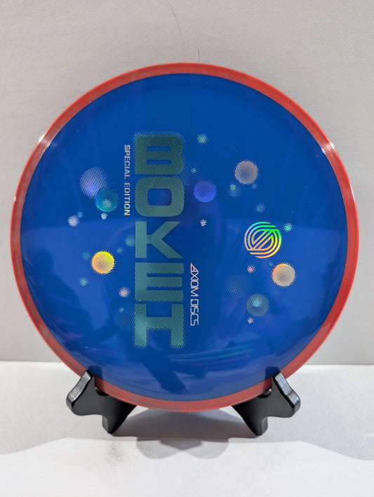 Blue disc with red rim on a stand against a white background