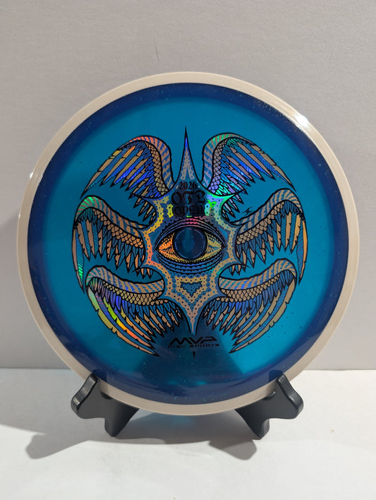 Blue disc with a metallic design on a stand against a gray background