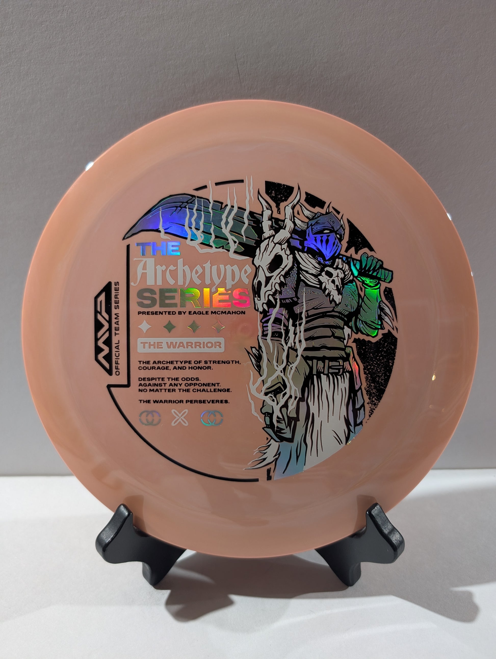 Disc with 'The Archetype Series' branding and warrior design on a stand against a gray background