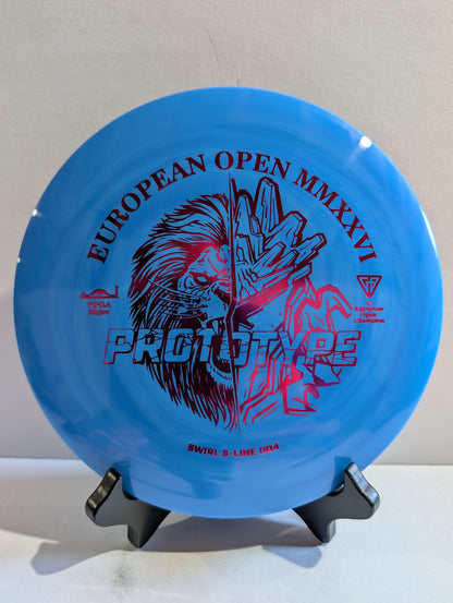 Blue disc golf disc with red and black graphics on a stand against a light gray background