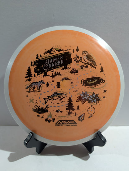 Orange disc with dark graphics and text on a stand against a gray background 