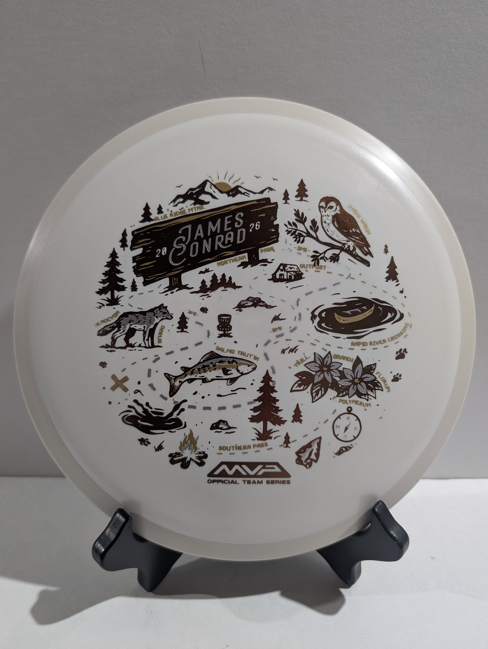 Disc with illustrations and text on a stand against a gray background