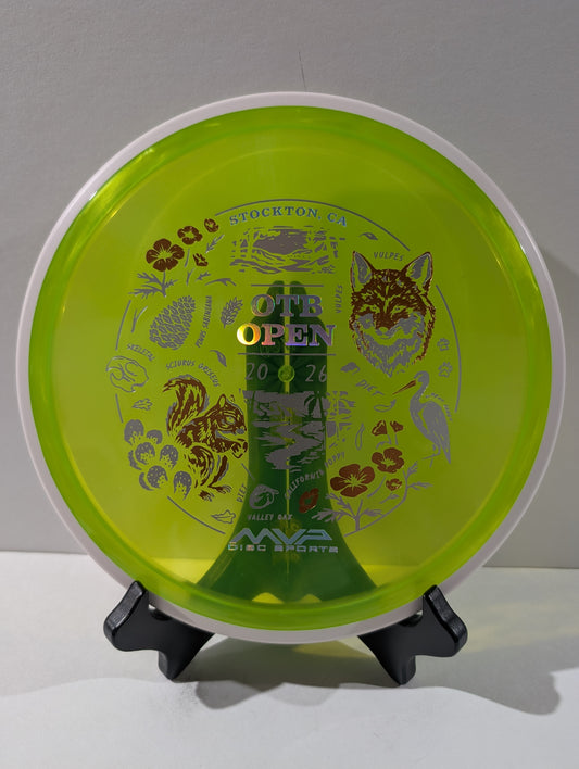Green disc golf disc with branding and text on a stand against a gray background