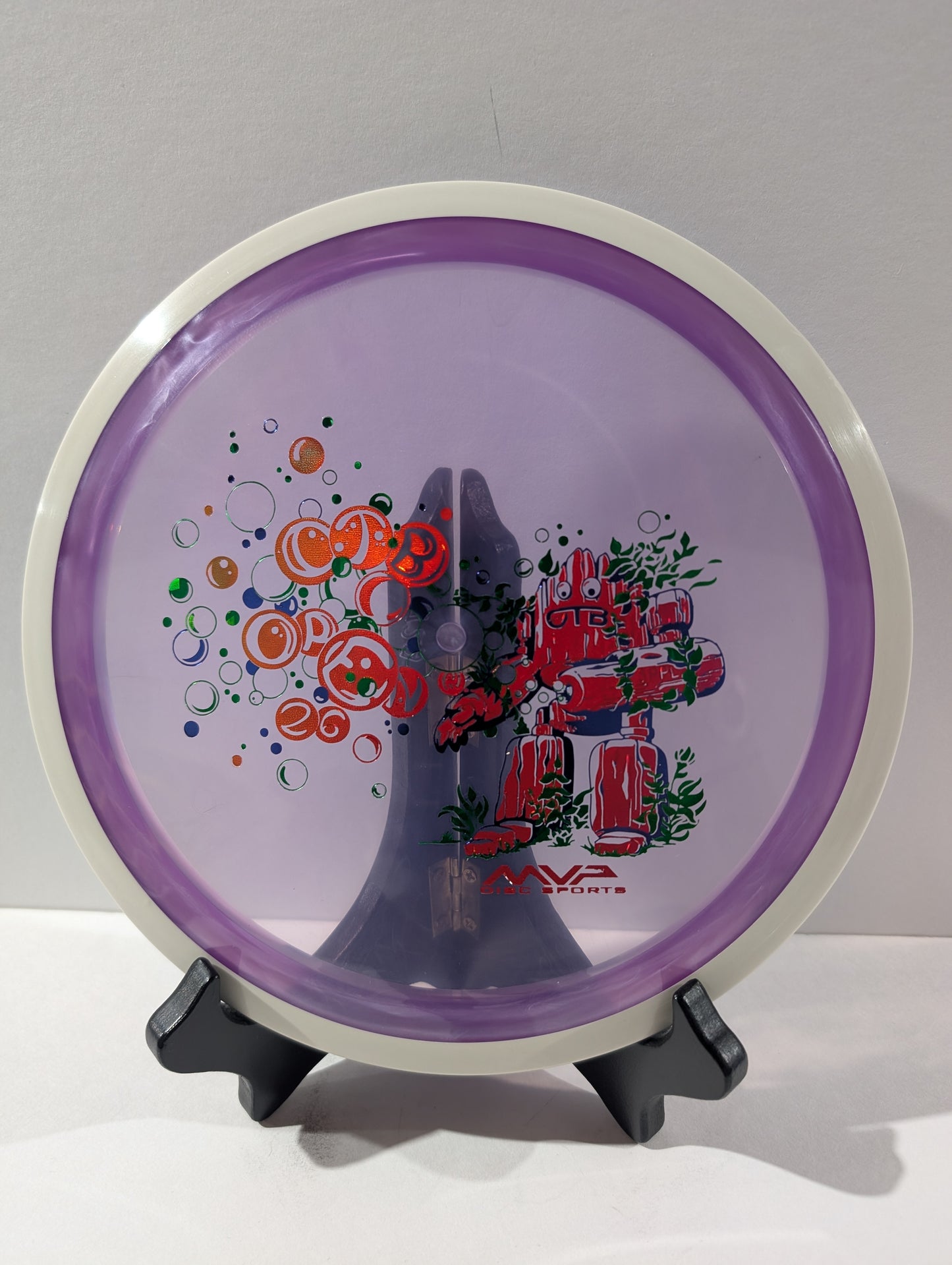Purple disc with colorful design on a stand against a gray background