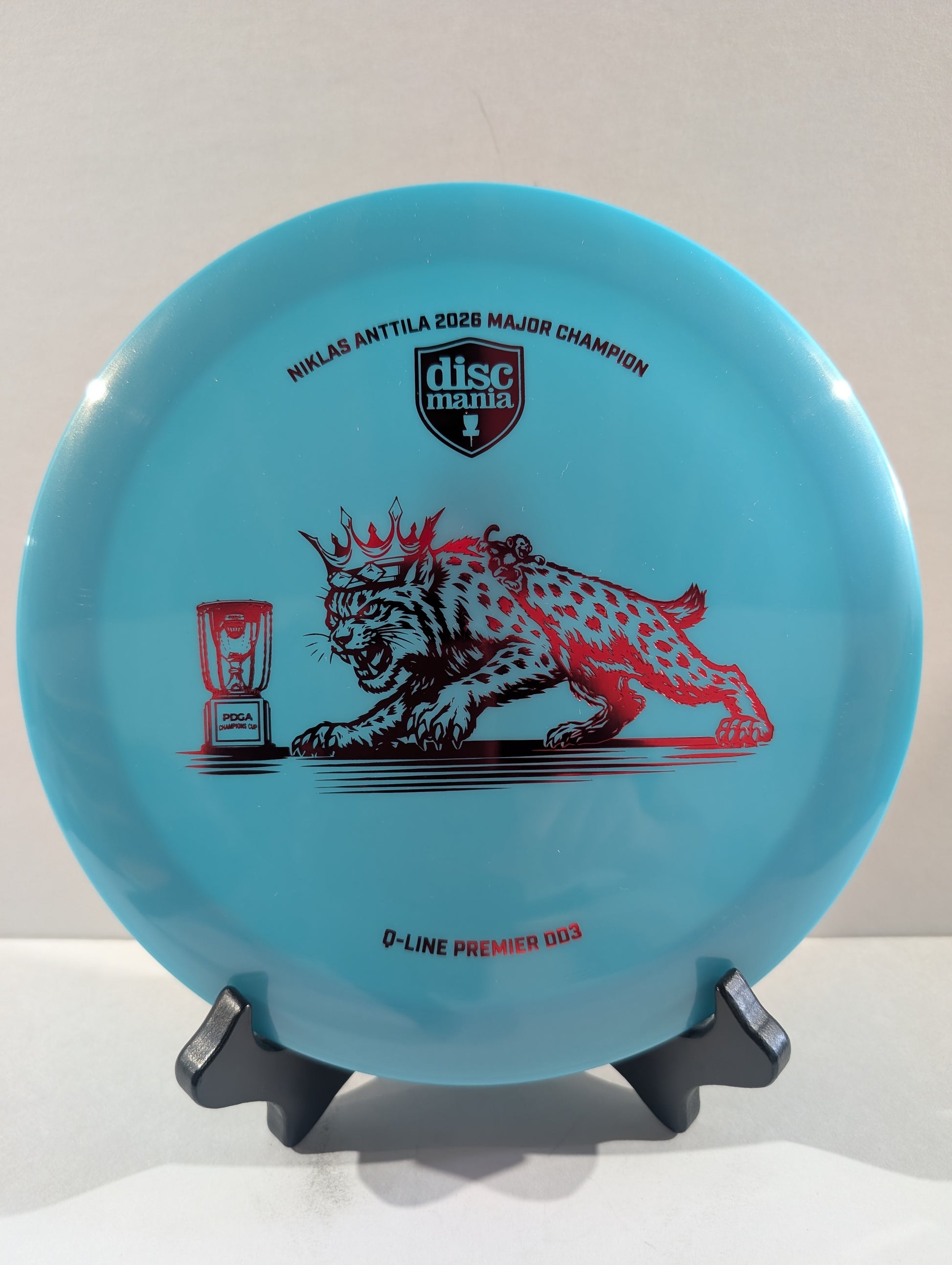 Blue disc with a red cat design on a white background