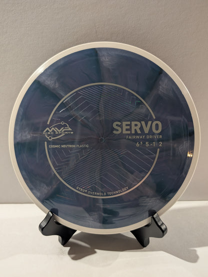 Disc golf disc with 'Servo' branding on a stand against a gray background