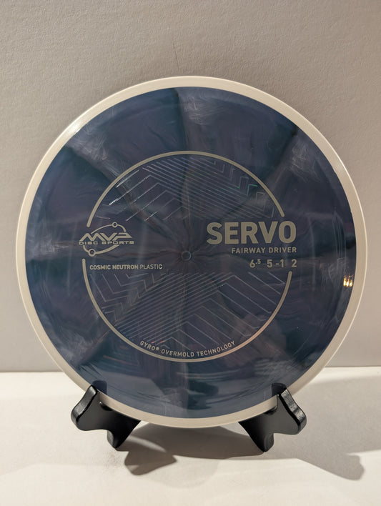 Disc golf disc with 'Servo' branding on a stand against a gray background