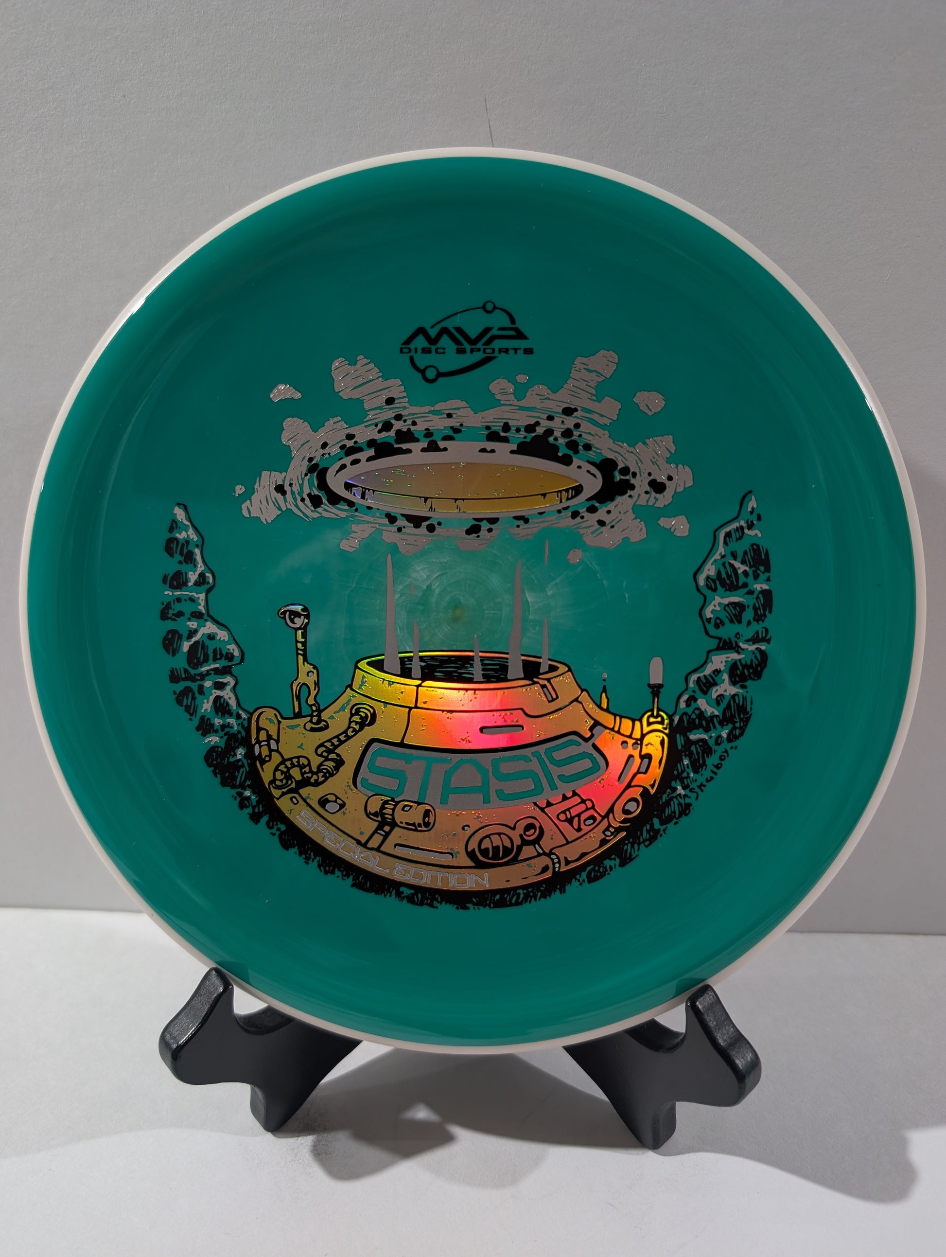 Green disc with a colorful design of a  'Stasis' branding on a gray background.