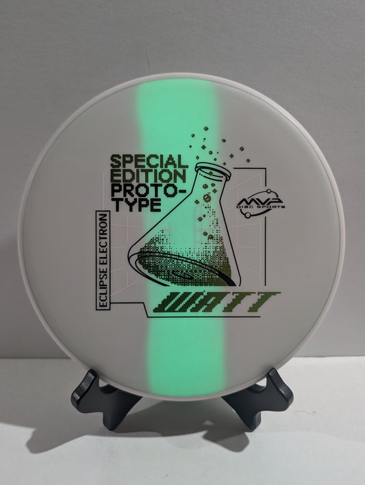 Disc with green glow-in-the-dark effect and text on a gray background