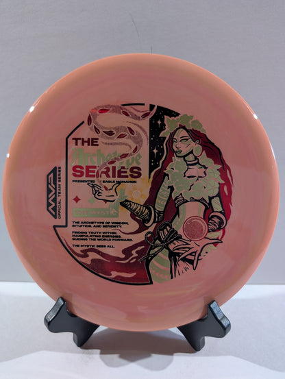 Peach disc with artistic design on a stand against a gray background