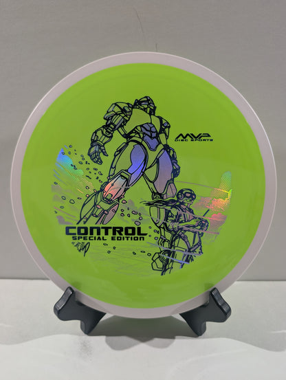 A disc golf disc on a small display stand, featuring a bright lime green background with black graphic illustrations of mecha robots and the text 'CONTROL SPECIAL EDITION' and 'MVP Disc Sports'.