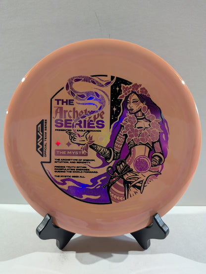 Disc golf disc with artistic design on a stand against a gray background