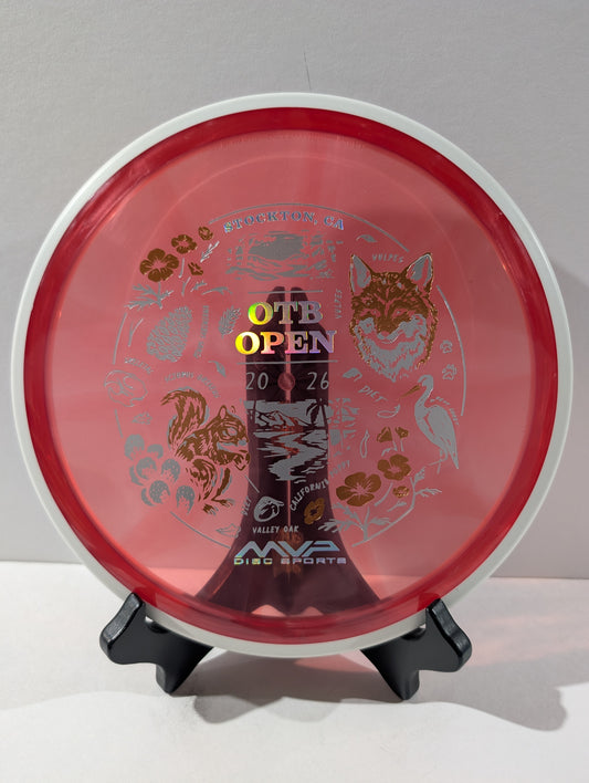 Red disc golf disc with branding and graphics on a stand against a gray background