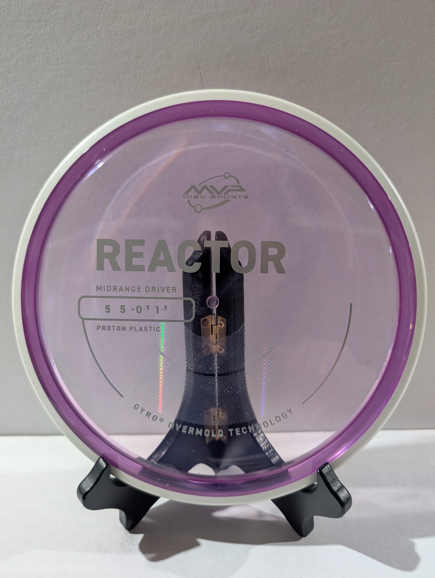 Disc golf disc with 'MVP' branding on a stand against a gray background