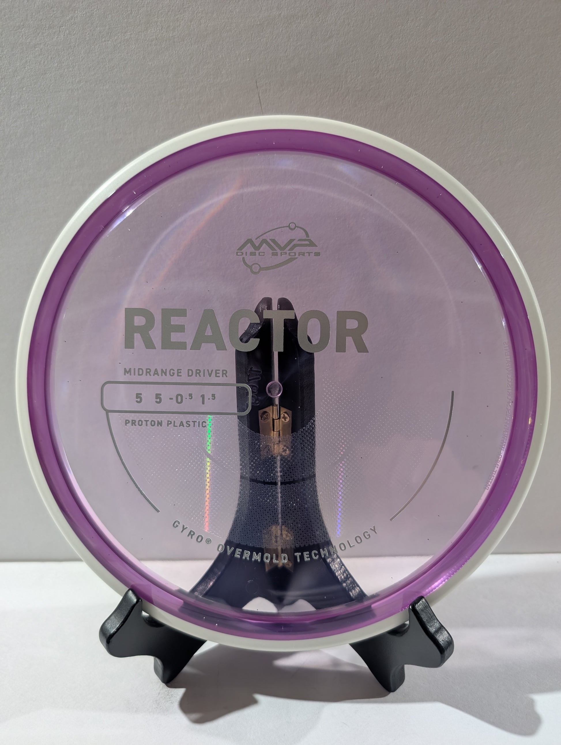 Disc golf disc with 'MVP' branding on a stand against a gray background