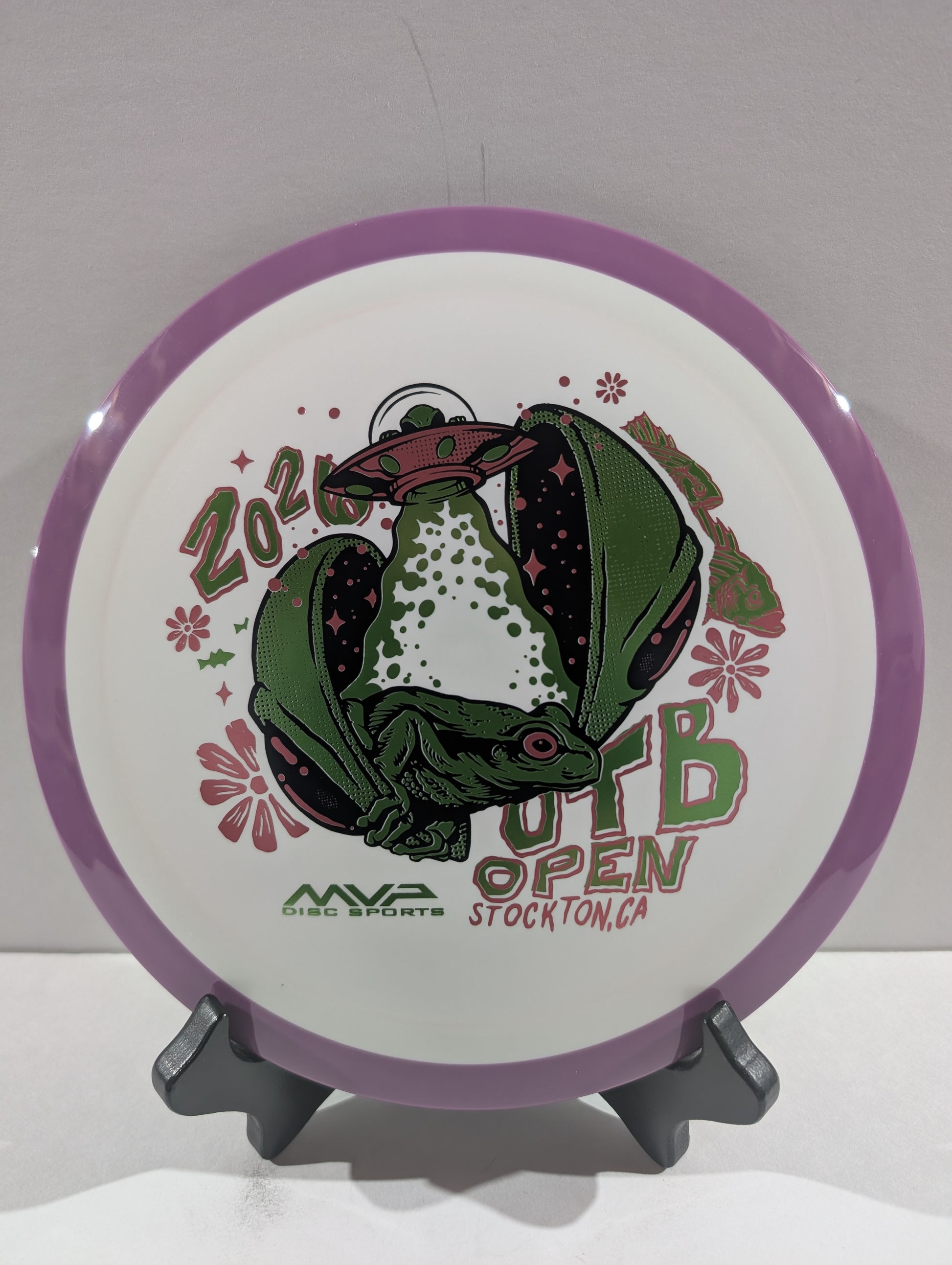Disc with a green alien design and text on a white background