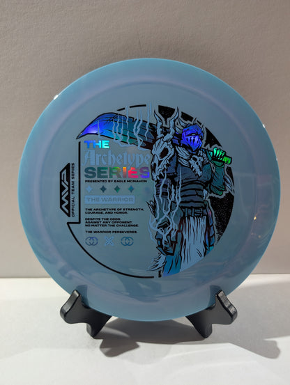 Light blue disc with warrior design and text on a stand against a neutral background