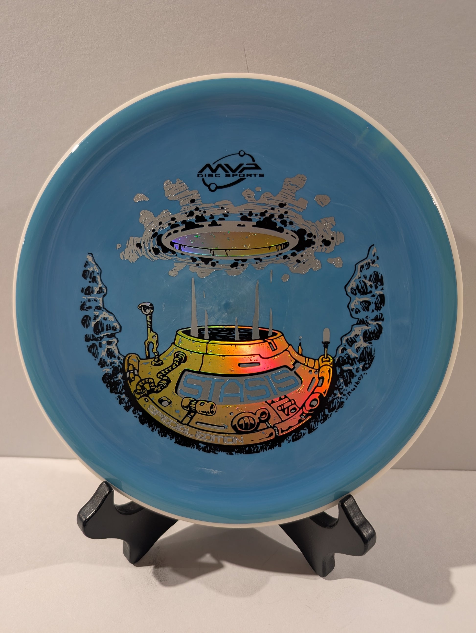 Blue disc with a colorful design, displayed on a stand.