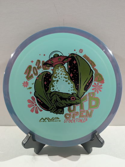 Disc with alien design and text on a stand against a white background