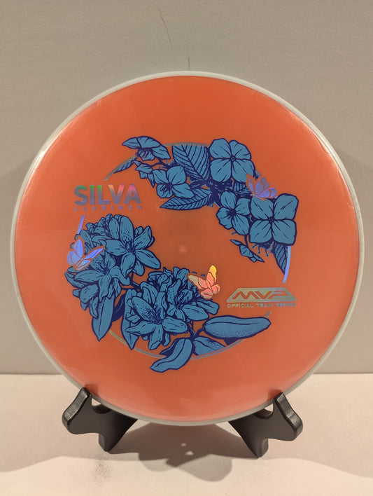 Orange disc with blue floral design and 'Silva' branding on a stand.