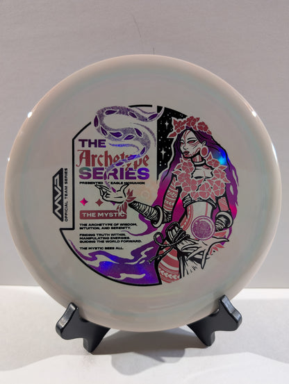 Disc with artistic design and text on a stand against a gray background
