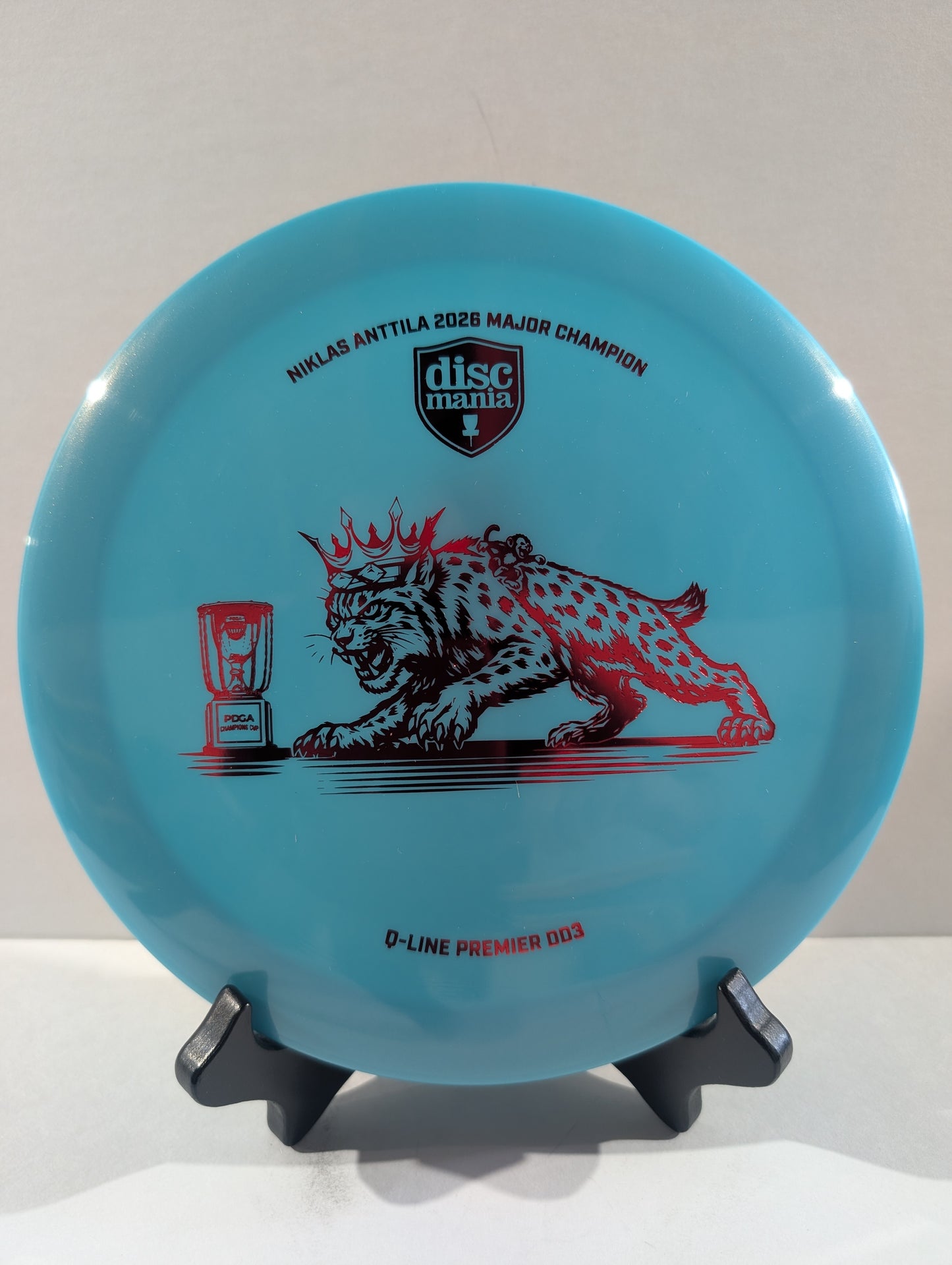 Blue disc with a red cat design on a white background