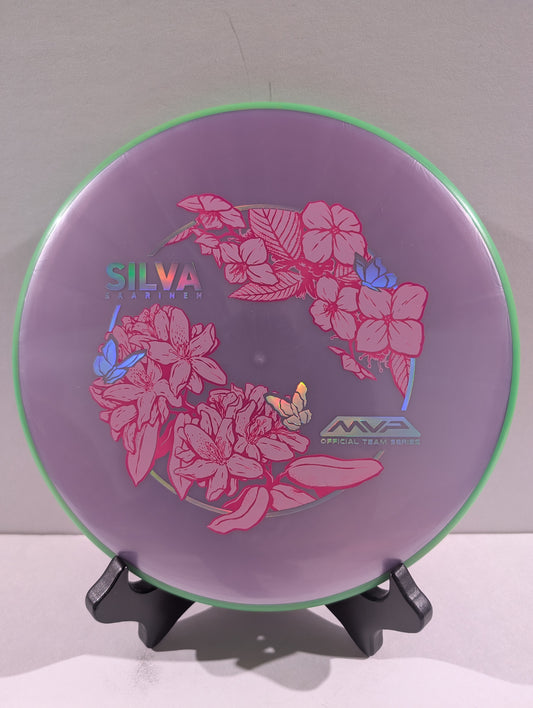 Purple disc with pink floral design on a stand against a gray background