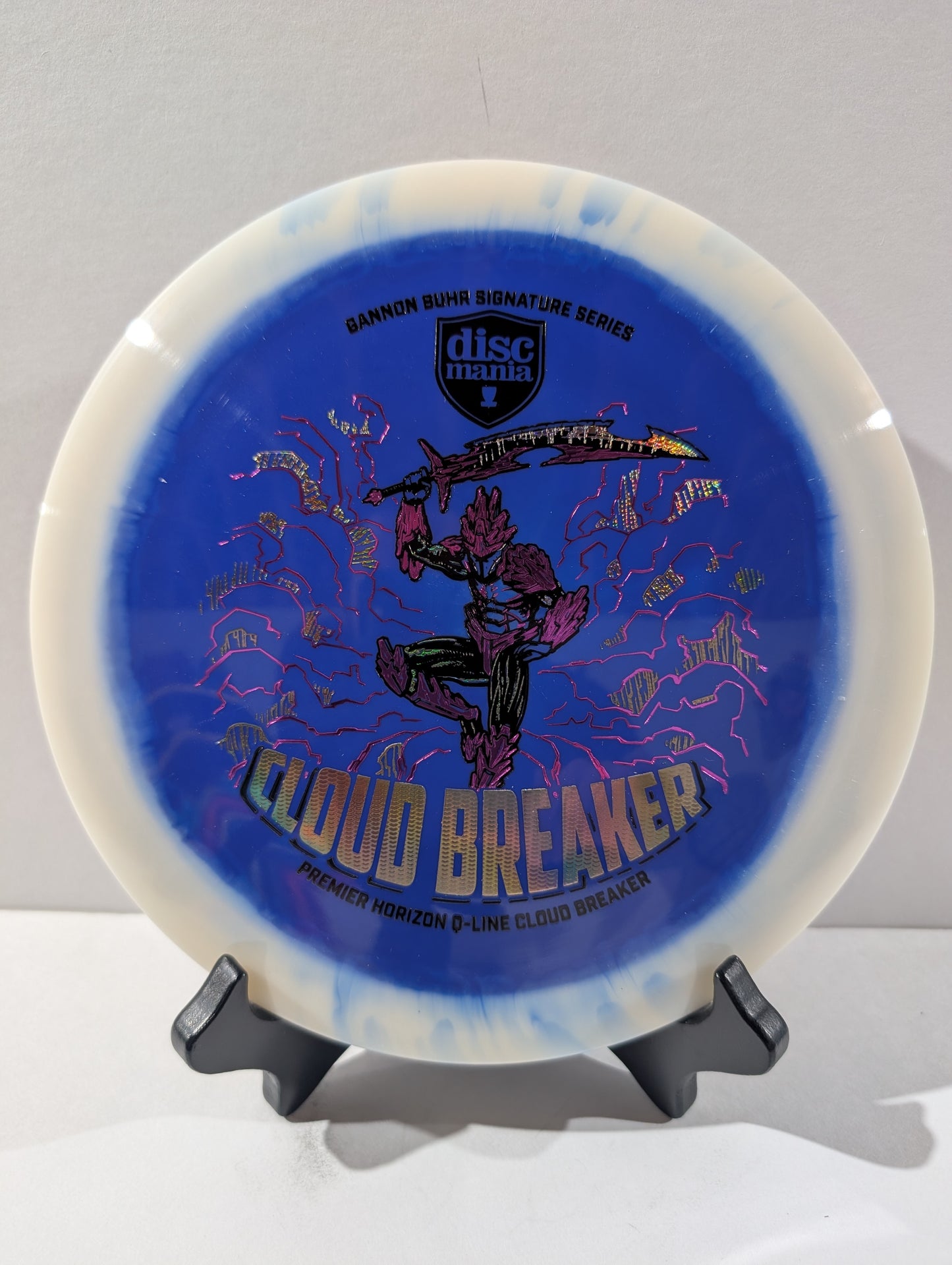 Disc with 'Cloud Breaker' design on a stand against a gray background