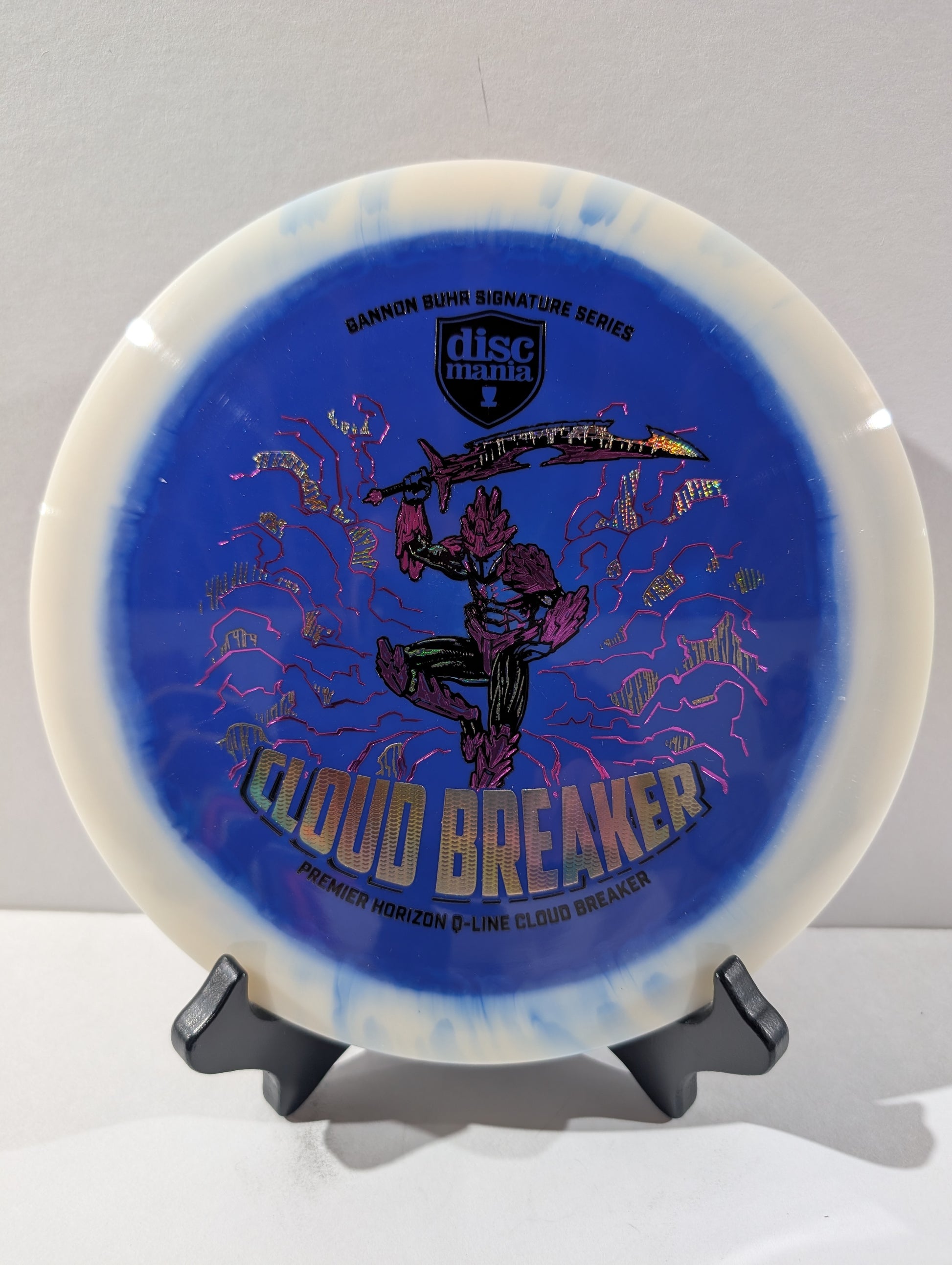 Disc with 'Cloud Breaker' design on a stand against a gray background