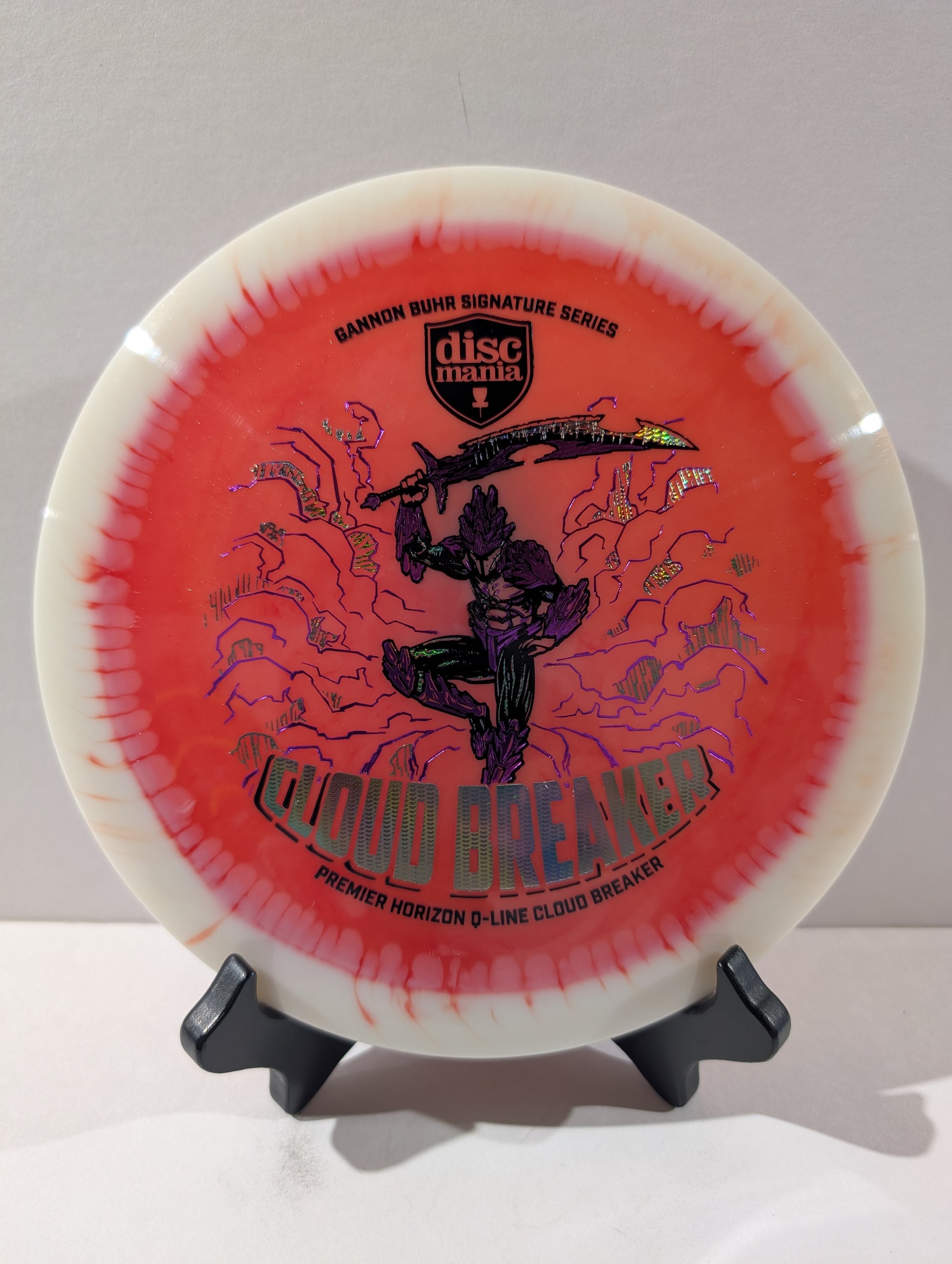 Discmania Cloud Breaker disc golf disc on a stand with a white background