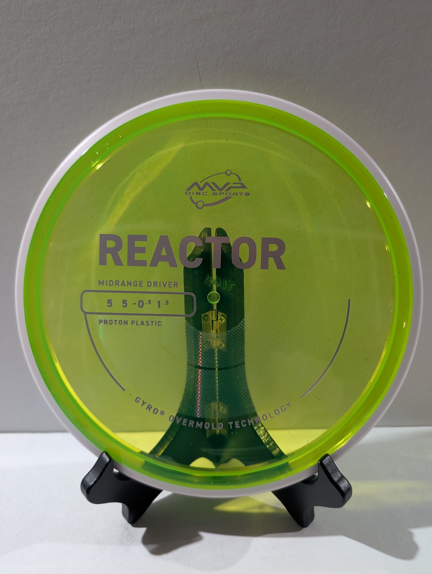 Disc golf disc with 'Reactor' branding on a stand against a gray background