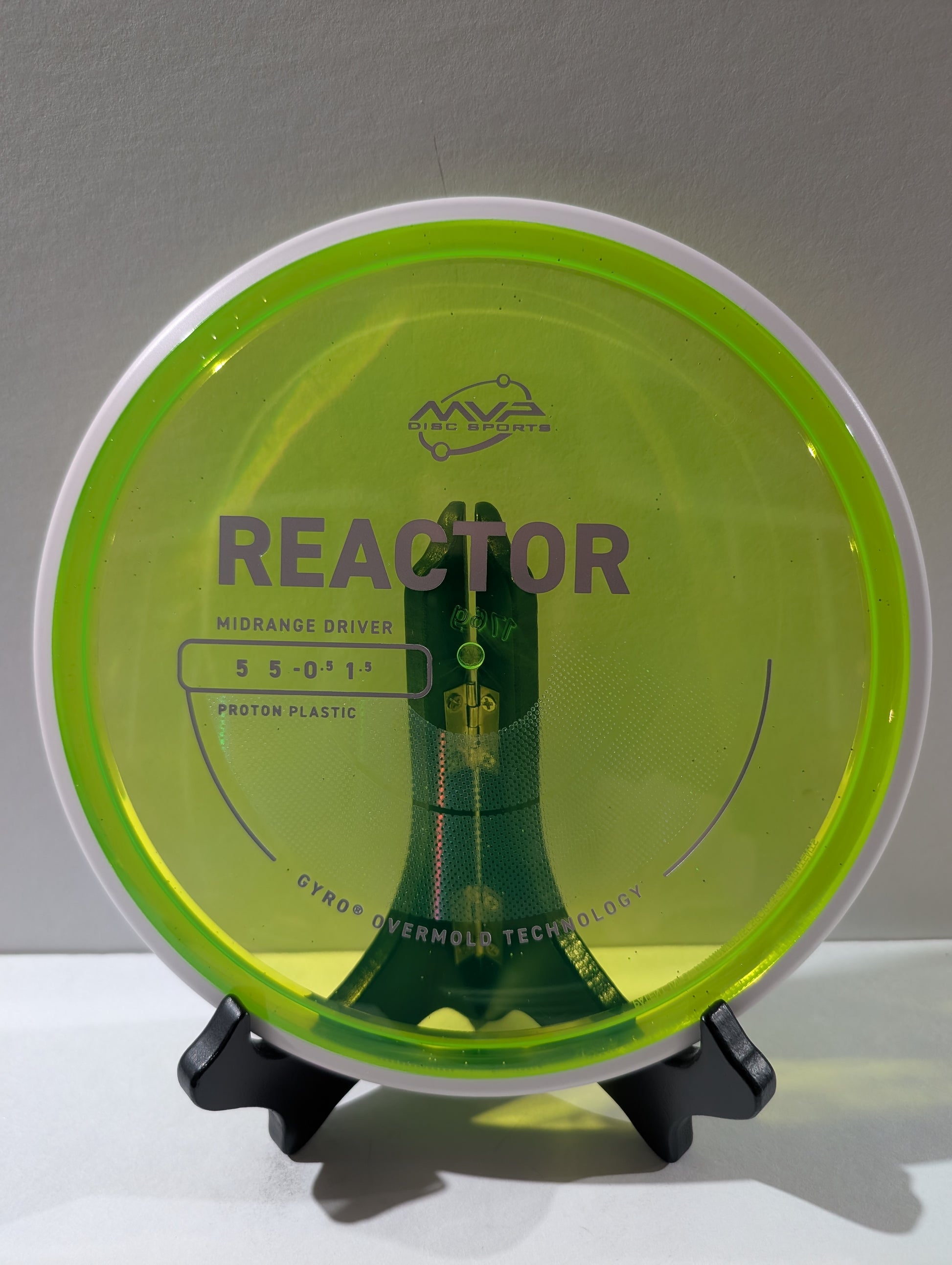 Disc golf disc with 'Reactor' branding on a stand against a gray background