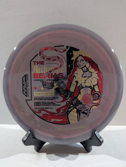 Disc golf disc with artistic design on a stand against a white background