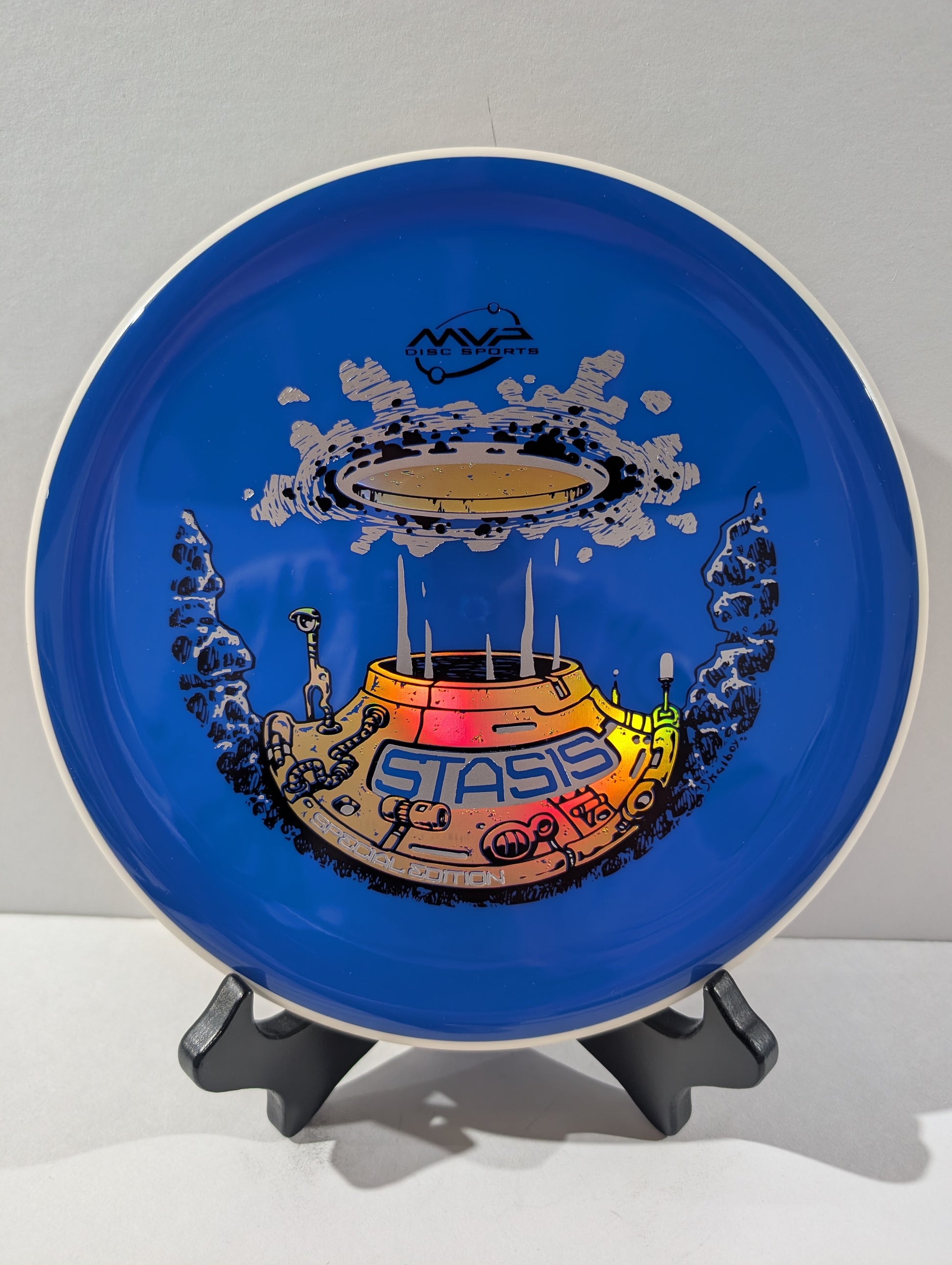 Blue disc with a colorful design on a stand against a gray background