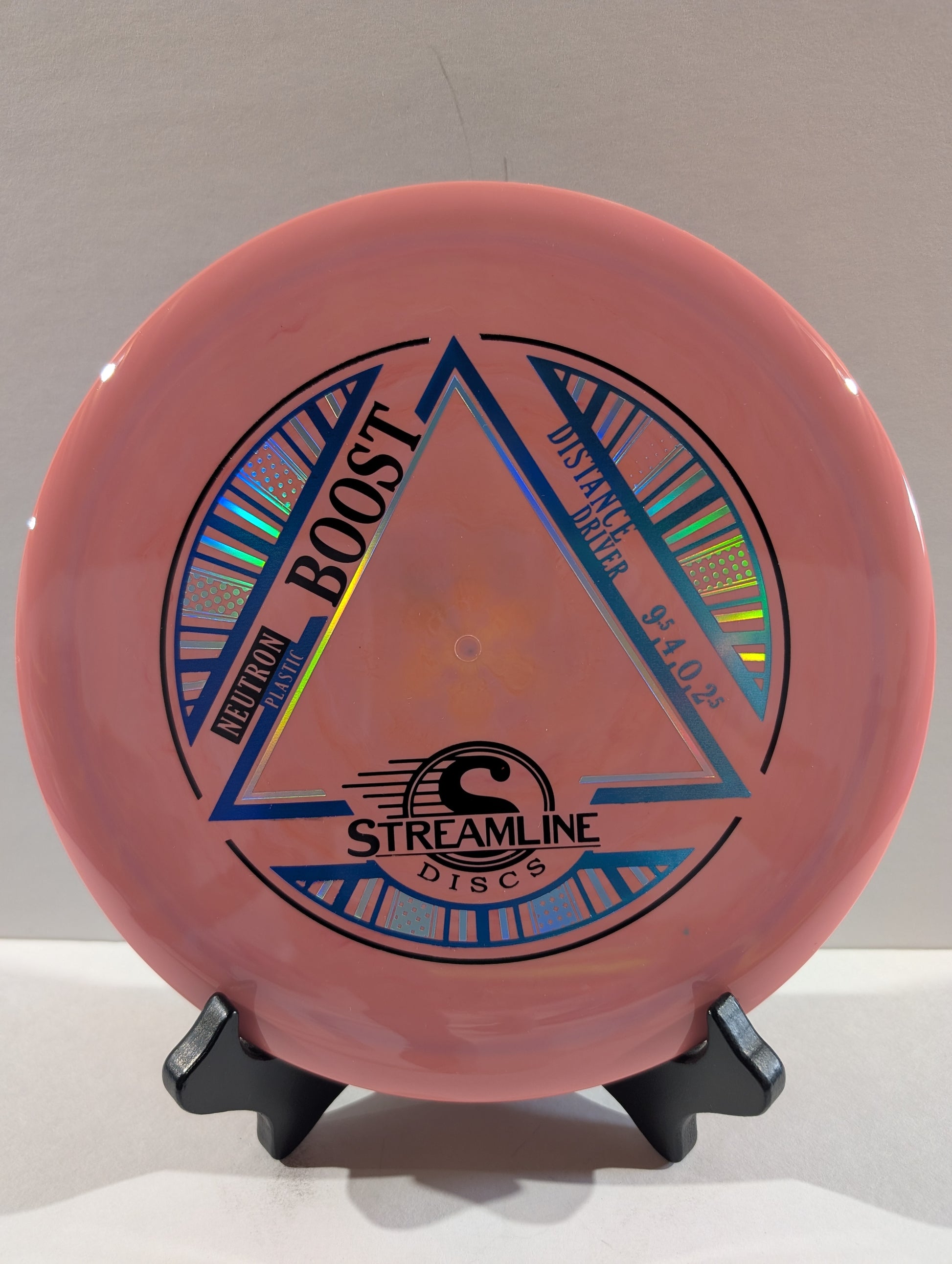 Pink disc with 'Streamline Discs' branding on a stand against a neutral background
